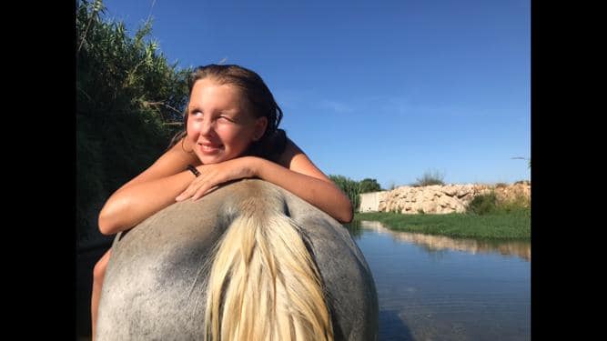Bañando al caballo en el río